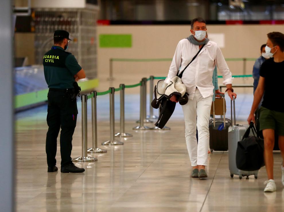 Passengers arrive at Adolfo Suarez Barajas airport in Madrid