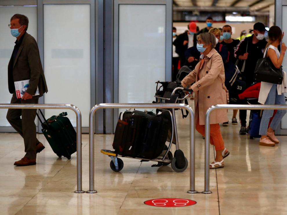 Passengers arrive at Adolfo Suarez Barajas airport in Madrid