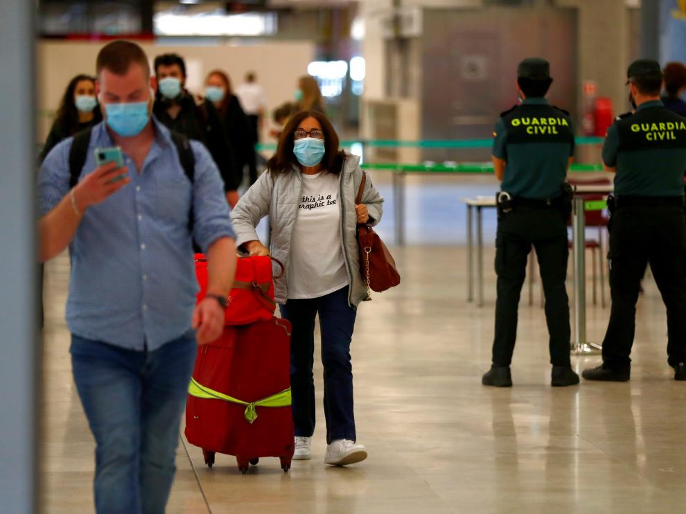 Passengers arrive at Adolfo Suarez Barajas airport in Madrid