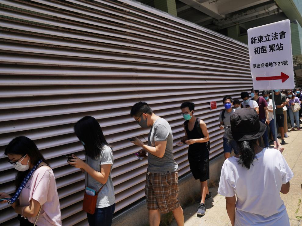 People line up to vote in the primary election aimed at selecting democracy candidates for the September election, in Hong Kong