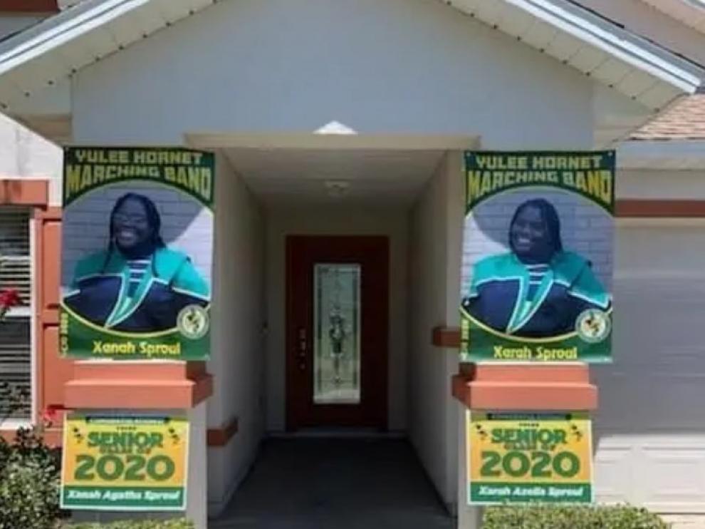 La imagen de las dos jóvenes graduadas que desplegaron orgullosos sus padres en la vivienda se ha hecho viral a raíz de la polémica carta racista que fue publicada en redes en señal de denuncia.