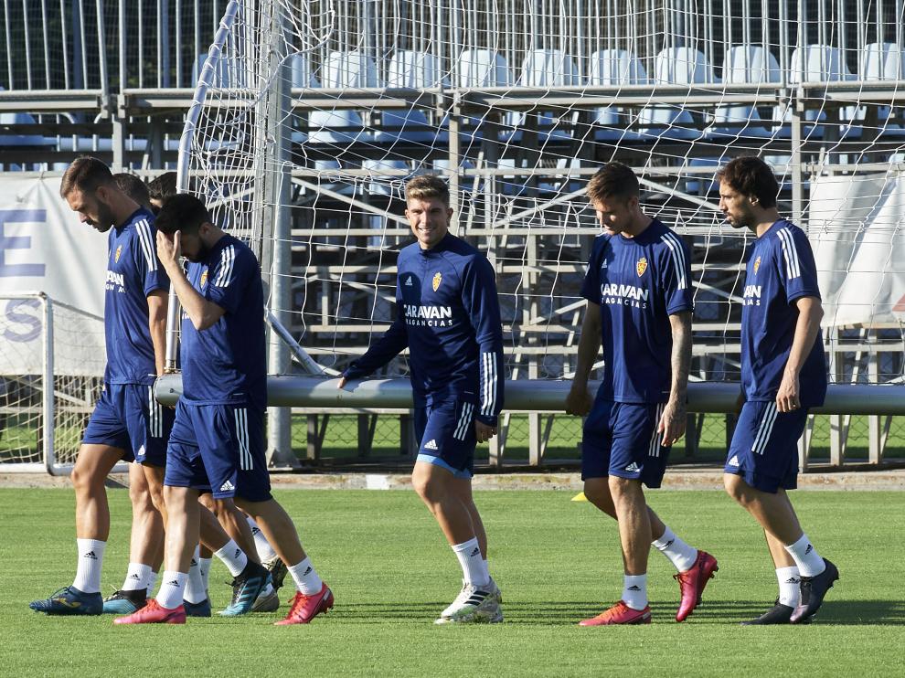 Varios jugadores del Real Zaragoza trasladan una portería en el entrenamiento de ayer.