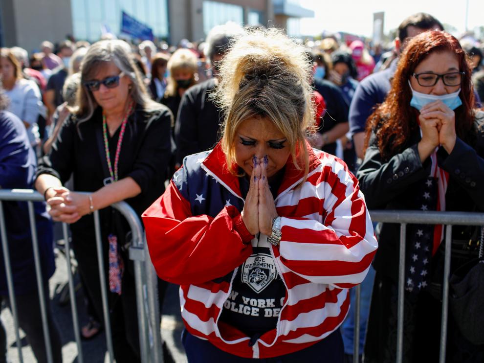People pray for U.S. President Donald Trump, who was diagnosed with the coronavirus disease (COVID-19), in New York City