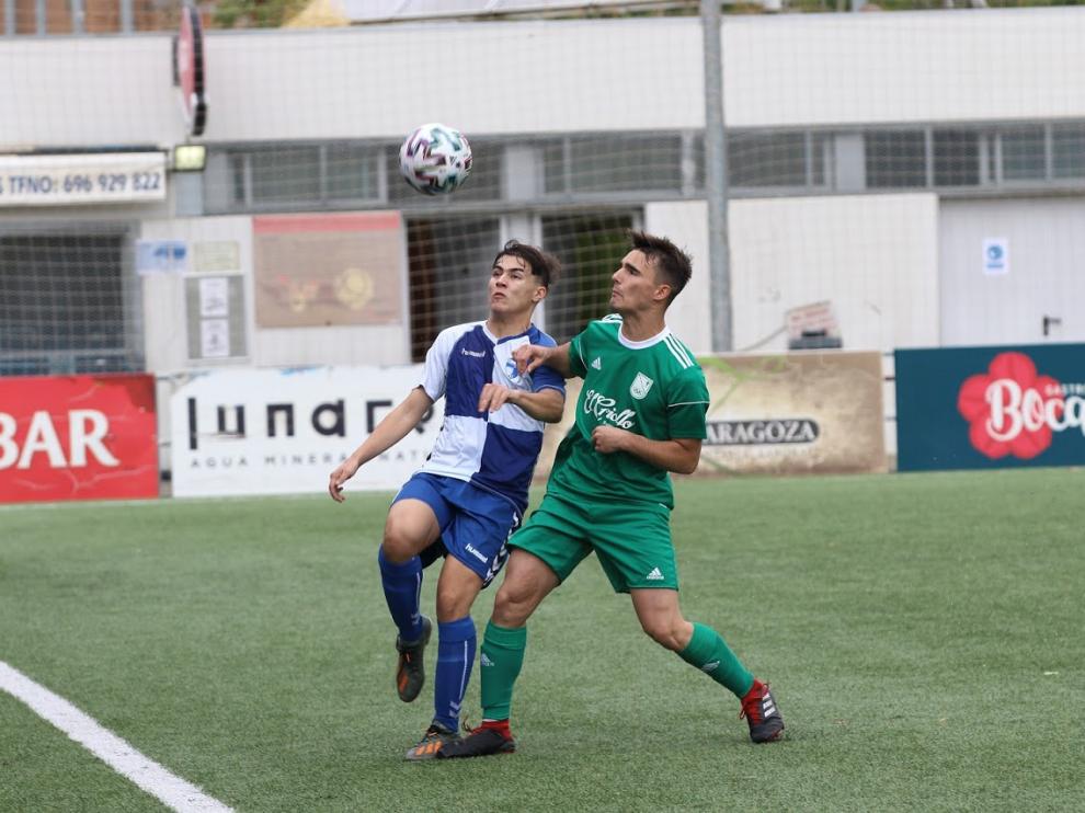Dos jugadores disputan un balón suelto.