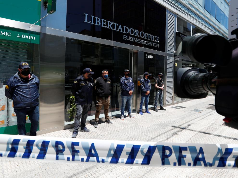 Police officers stand guard outside the building where Dr. Luque has his office in Buenos Aires