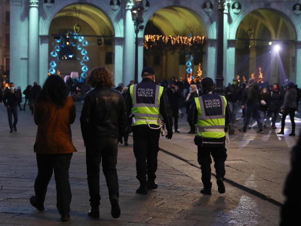 Dos policías patrullan por una calle de Brescia.