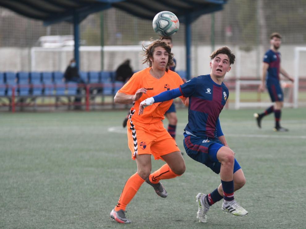 Dos jugadores luchan por un balón dividido.