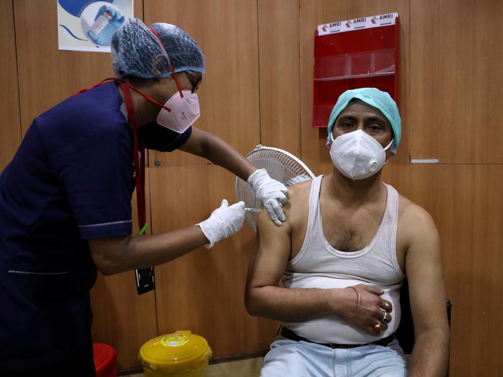 FILE PHOTO: A healthcare worker receives a dose of COVISHIELD at a hospital in Kolkata