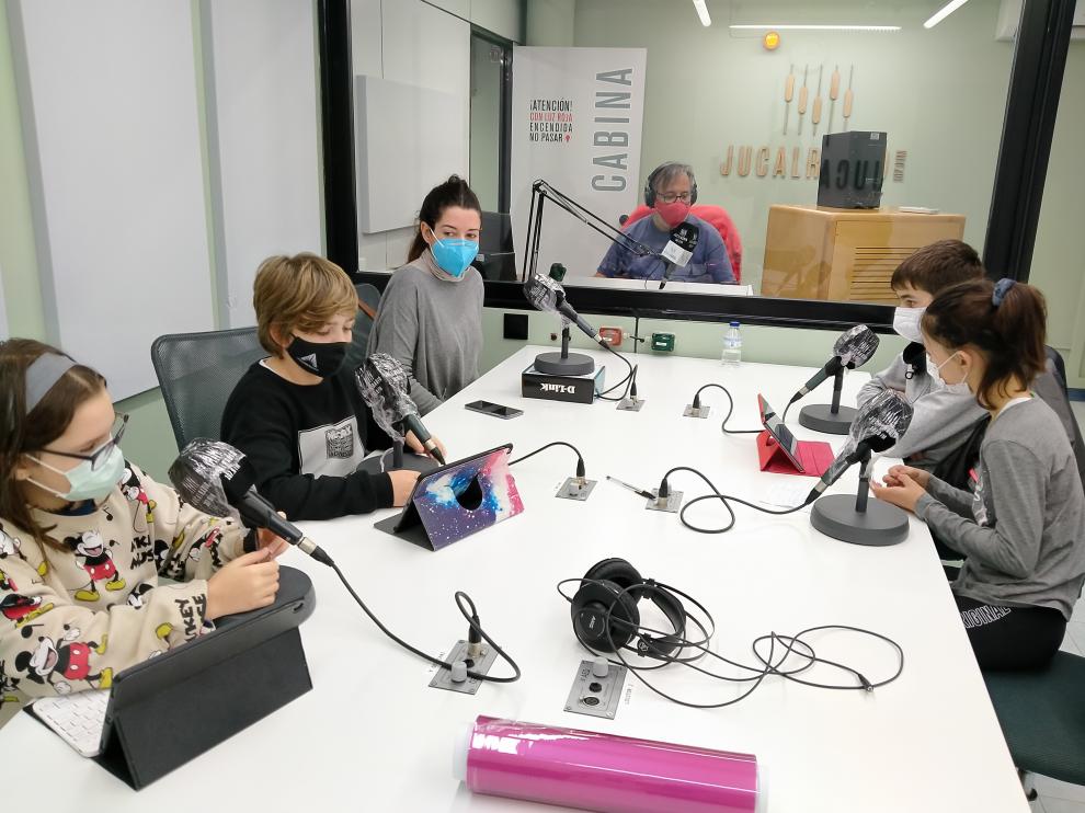Alumnos del CEIP Los Albares de La Puebla de Alfindén, en una de las habituales grabaciones de su programa de radio en la emisora local