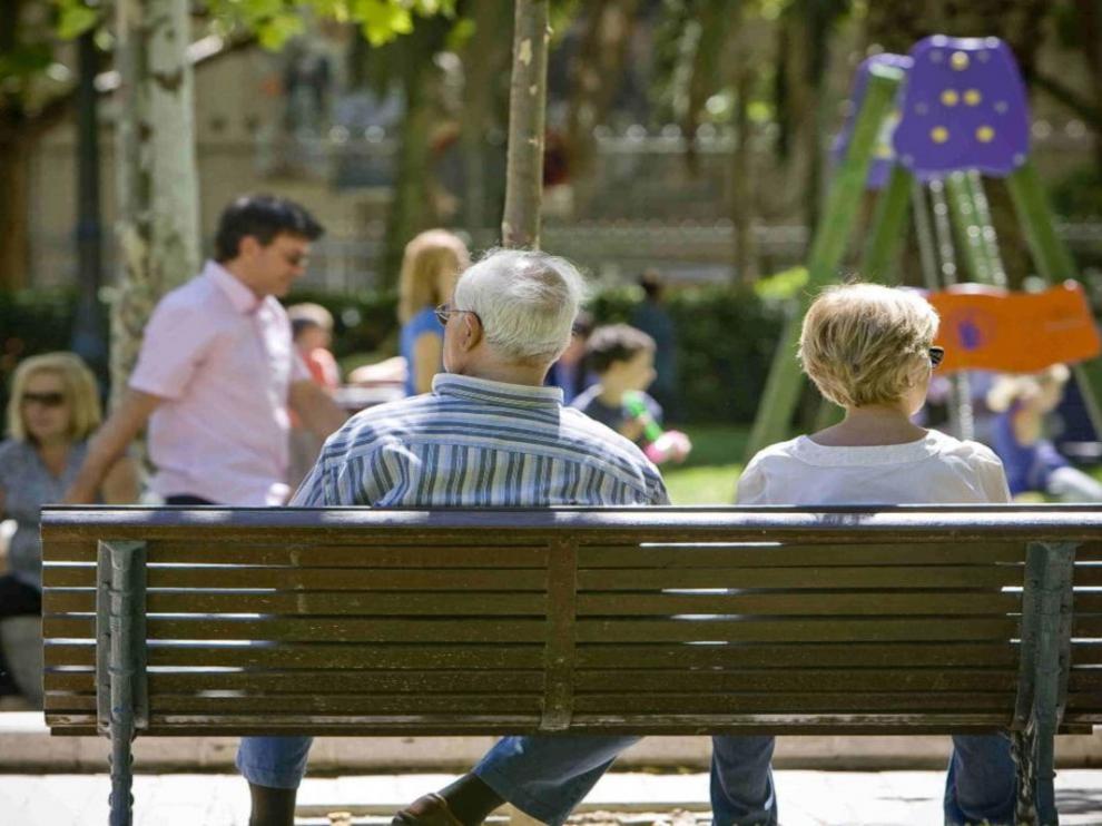 Una pareja sentada en un banco en Zaragoza.