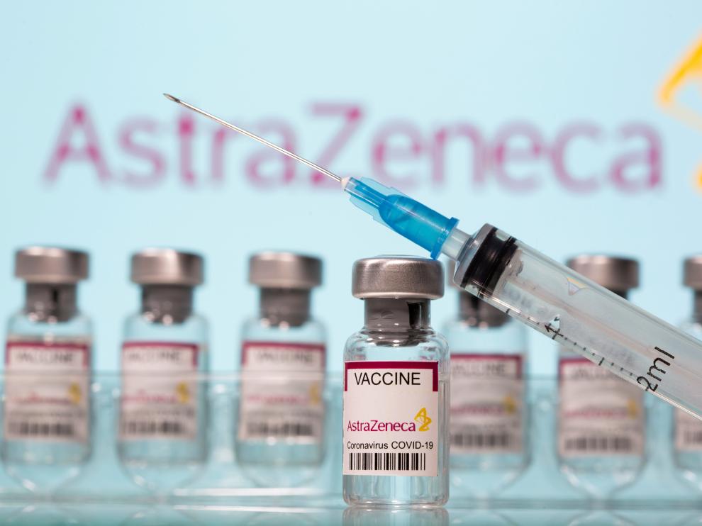 FILE PHOTO: Vials labelled "AstraZeneca COVID-19 Coronavirus Vaccine" and a syringe are seen in front of a displayed AstraZeneca logo