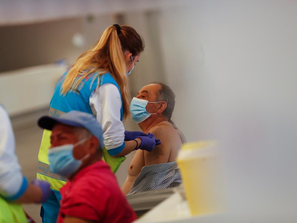 Man receives an injection with AstraZeneca's COVID-19 vaccine at a vaccination centre, in Madrid