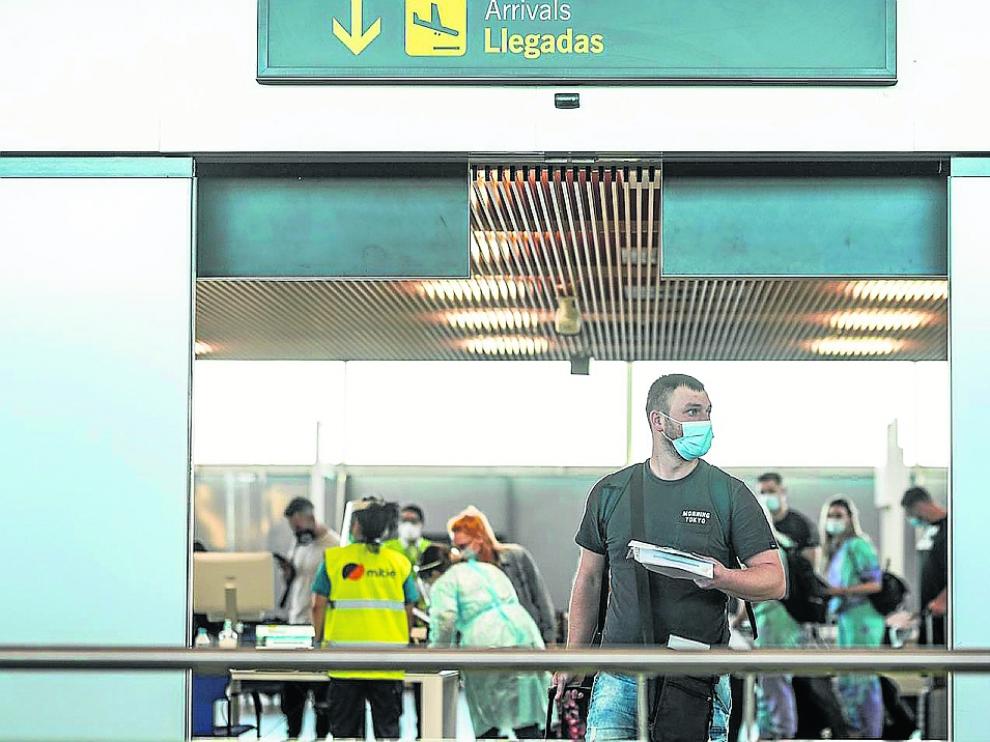 Viajeros procedentes de Rumanía y de Reino Unido, ayer, en el aeropuerto de Zaragoza