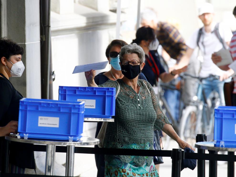 Swiss voters decide on COVID, CO2 laws