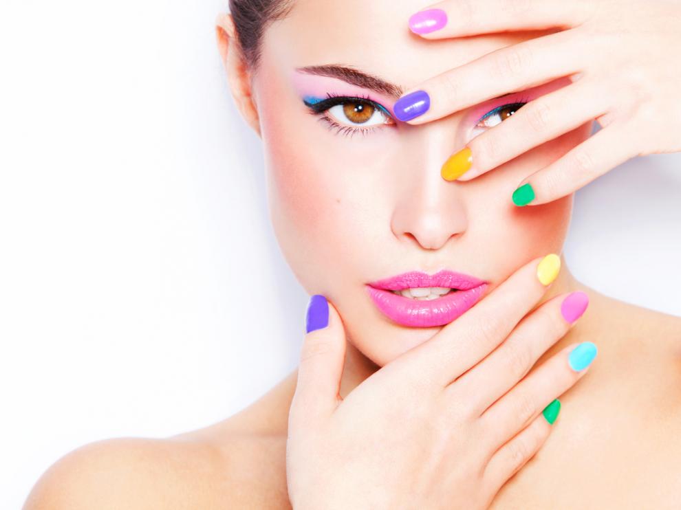 Mujer con manicura especial con uñas de colores distintos