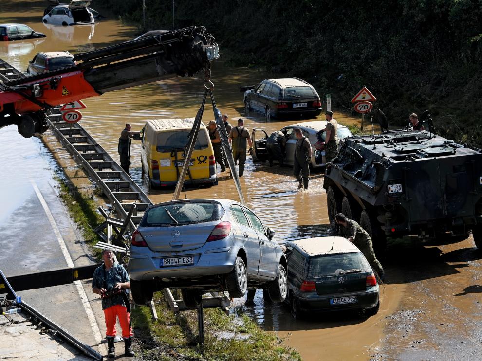 Erftstadt (Germany), 17/07/2021.- Rescue services clear wrecked cars and trucks from the B265 federal highway in Erftstadt, Germany, 17 July 2021. Large parts arts of central Eruope were hit by heavy, continuous rain resulting in local flash floods that destroyed buildings and swept away cars. At least 140 people died in Germany. (Inundaciones, Alemania) EFE/EPA/SASCHA STEINBACH Floodings in Germany