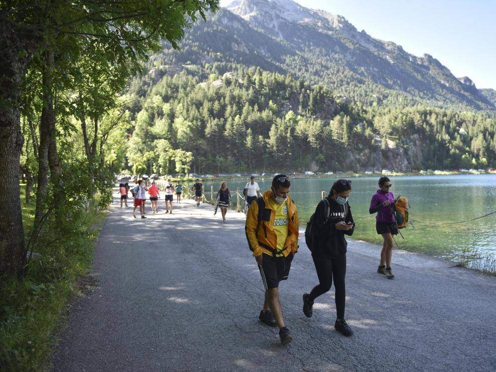 Visitantes accediendo este sábado al balneario de Panticosa, que pronto llenó sus aparcamientos, para hacer rutas de montaña.