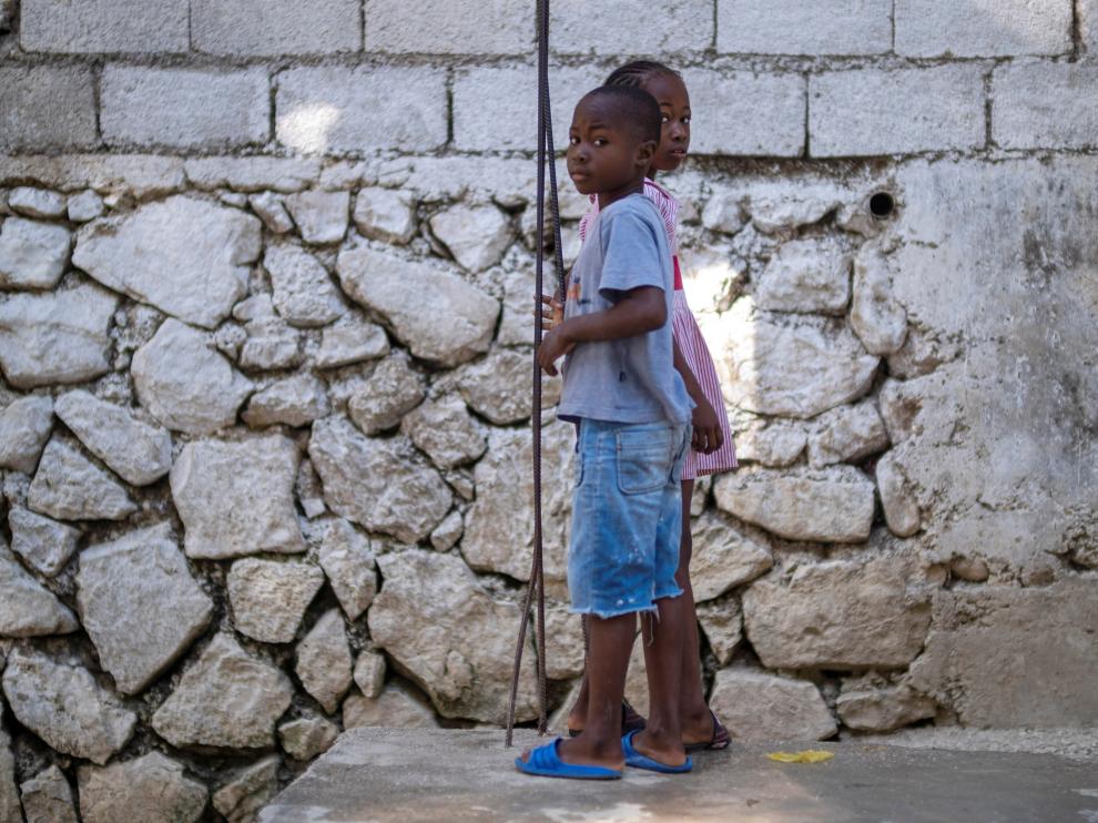 Two children look a the camera while playing in Port-au-Prince