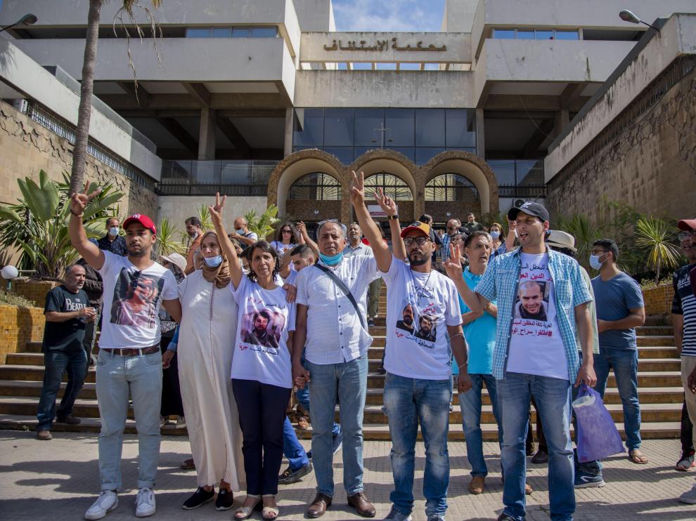 La madre del periodista condenado, junto a otras personas que apoyan la causa de su hijo, a las puertas del tribunal