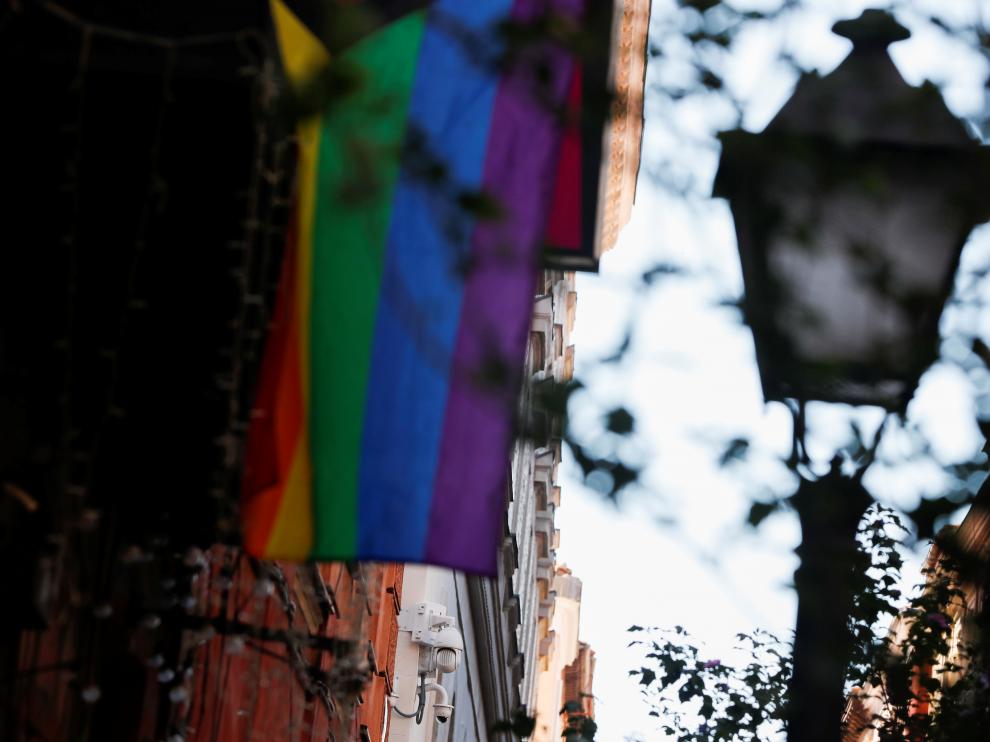 An LGBT flag hangs near surveillance cameras in Malasana neighbourhood, site of a suspected homophobic assault on a 20-year-old Spaniard in central Madrid