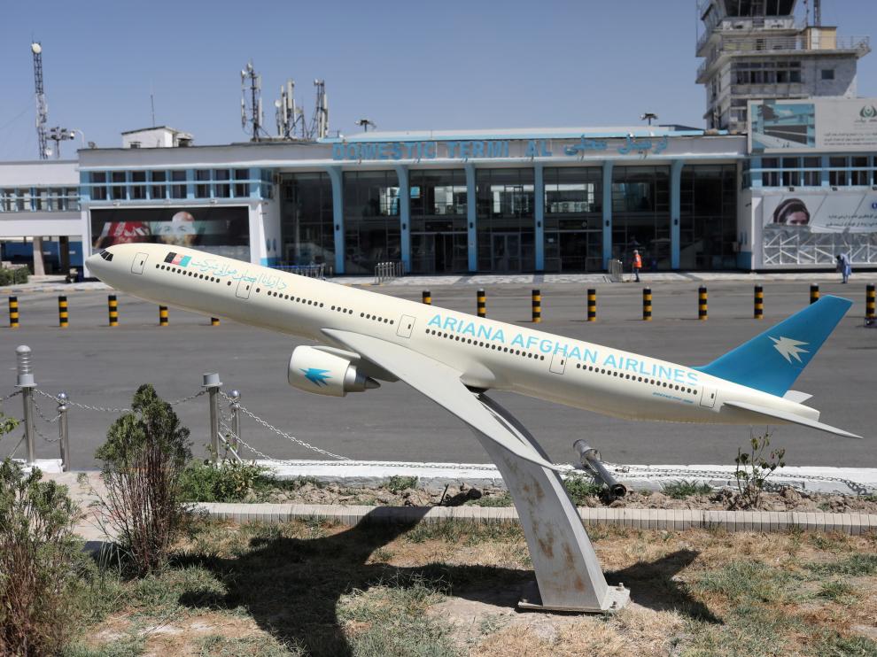 FILE PHOTO: Model of an Ariana Afghan Airlines airplane is seen in front of the international airport in Kabul
