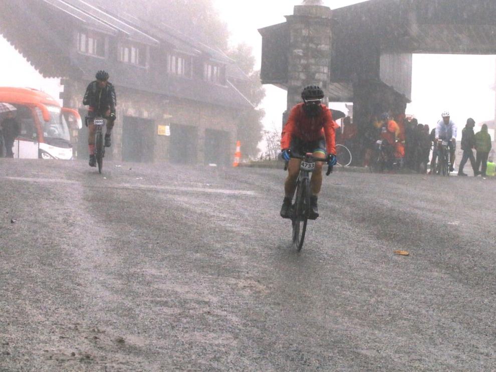 Los primeros ciclistas llegan a la frontera del Somport con la lluvia como protagonista de la jornada.