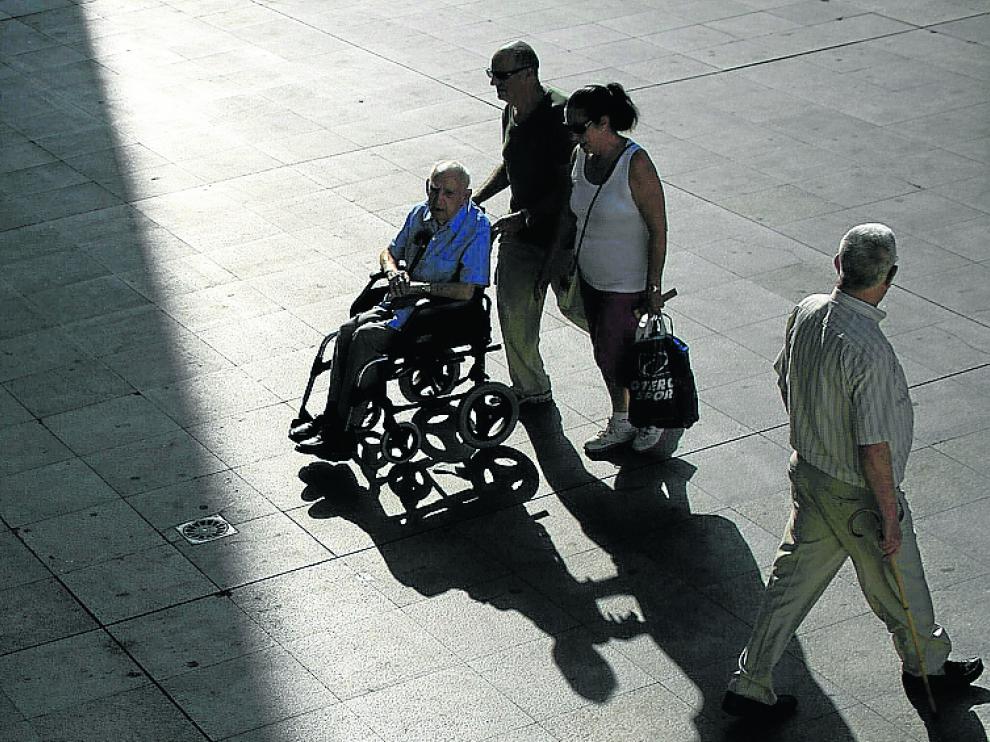 Unos pensionistas pasean por Sevilla.