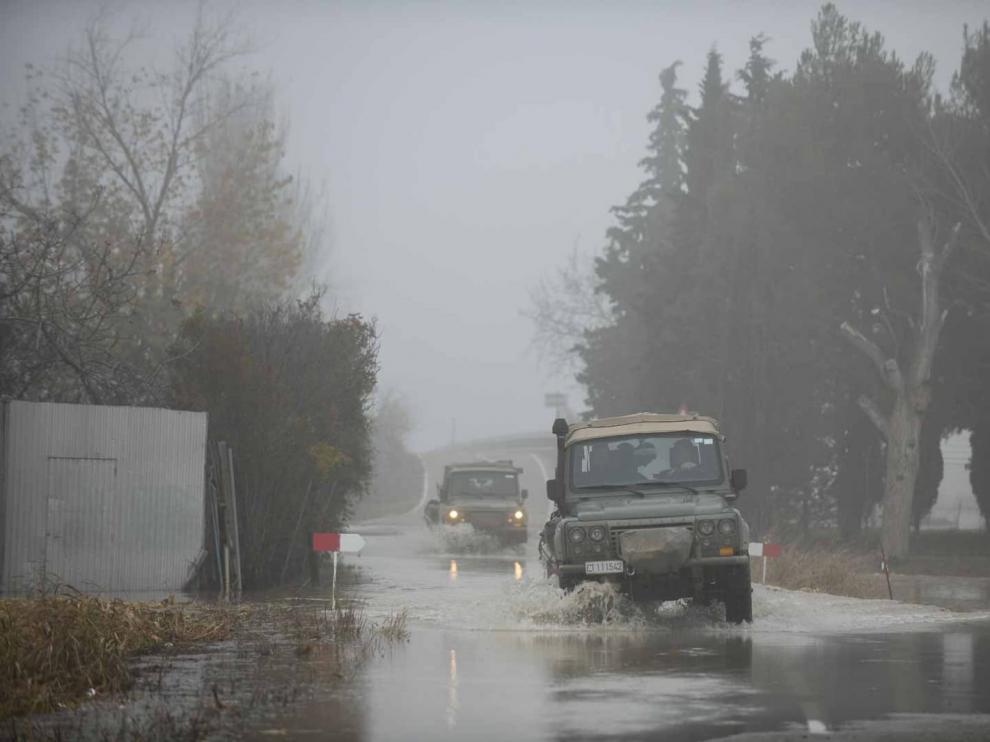 Dos vehículos militares, este lunes, en la carretera de acceso a Alfocea por Monzalbarba cortada por la crecida.