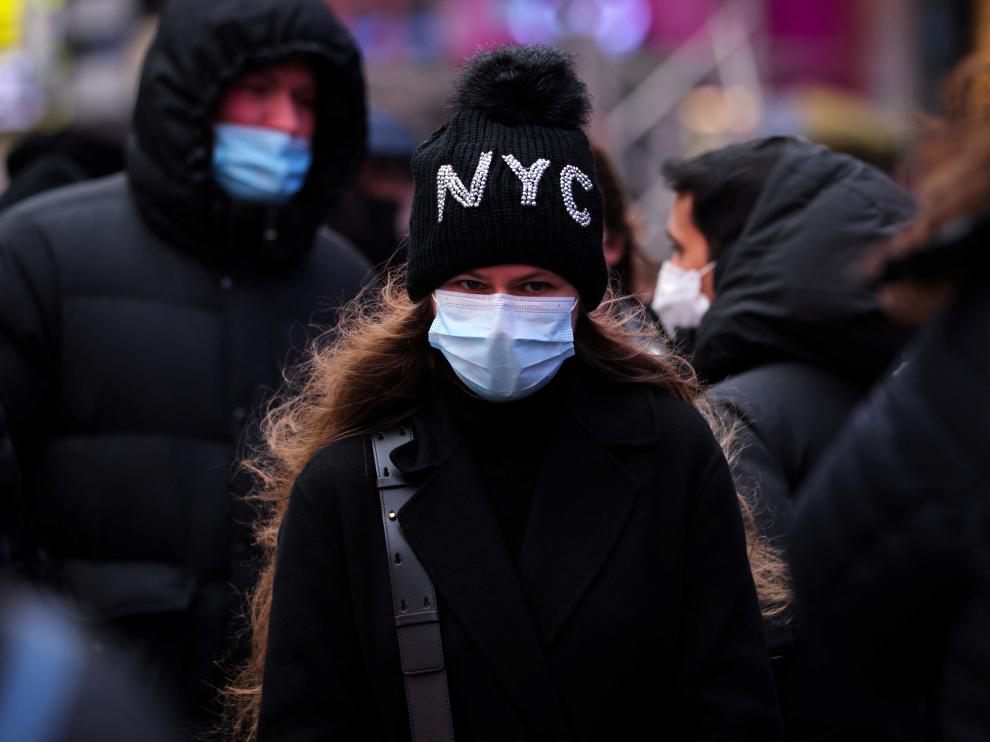A person waits in a queue for a coronavirus disease (COVID-19) test in Times Square as the Omicron coronavirus variant continues to spread in Manhattan, New York City