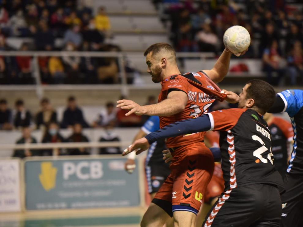 Asier Nieto, del Bada Huesca, sujetado por los jugadores del Sinfín.