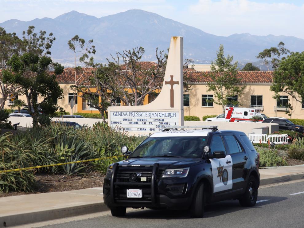 A police car is seen after a deadly shooting at Geneva Presbyterian Church in Laguna Woods