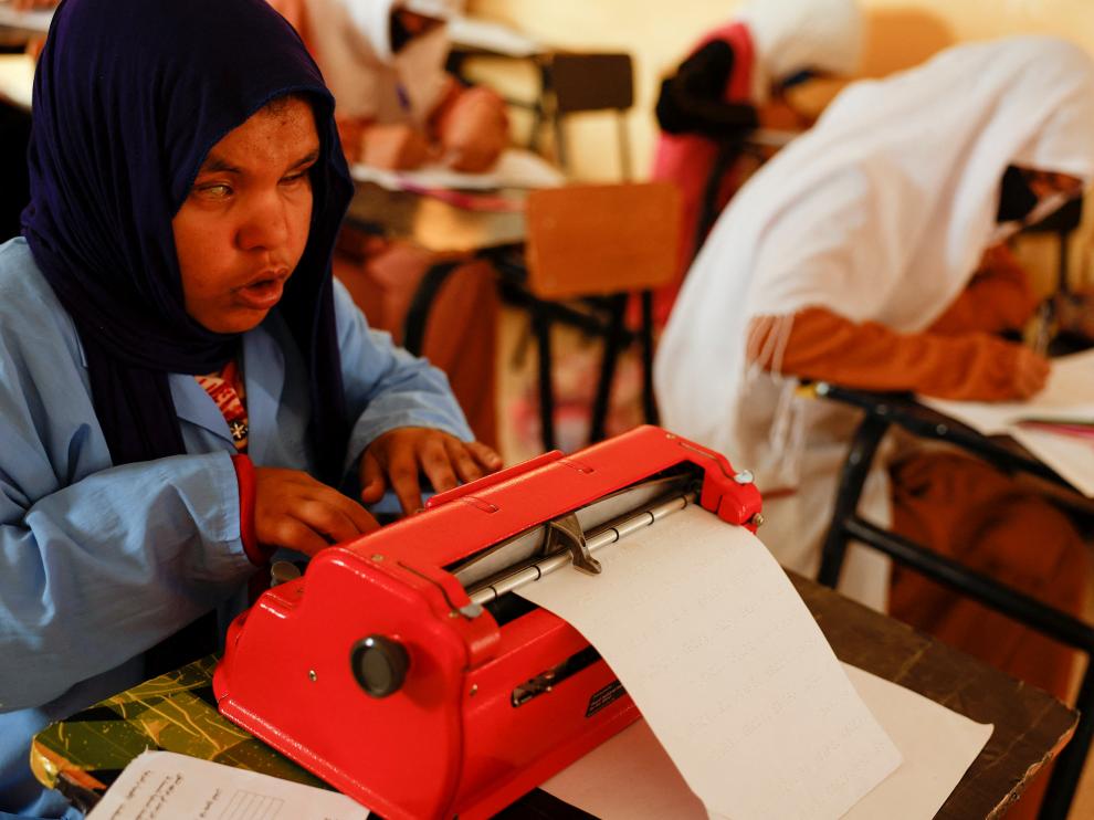 A blind Sahrawi girl performs a test with her classmates in Braille at the Smara refugee camp, in Tindouf