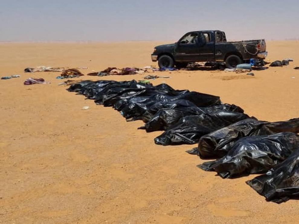 Security personnel recover bodies of migrants in the area between Kufra city and Chadian border