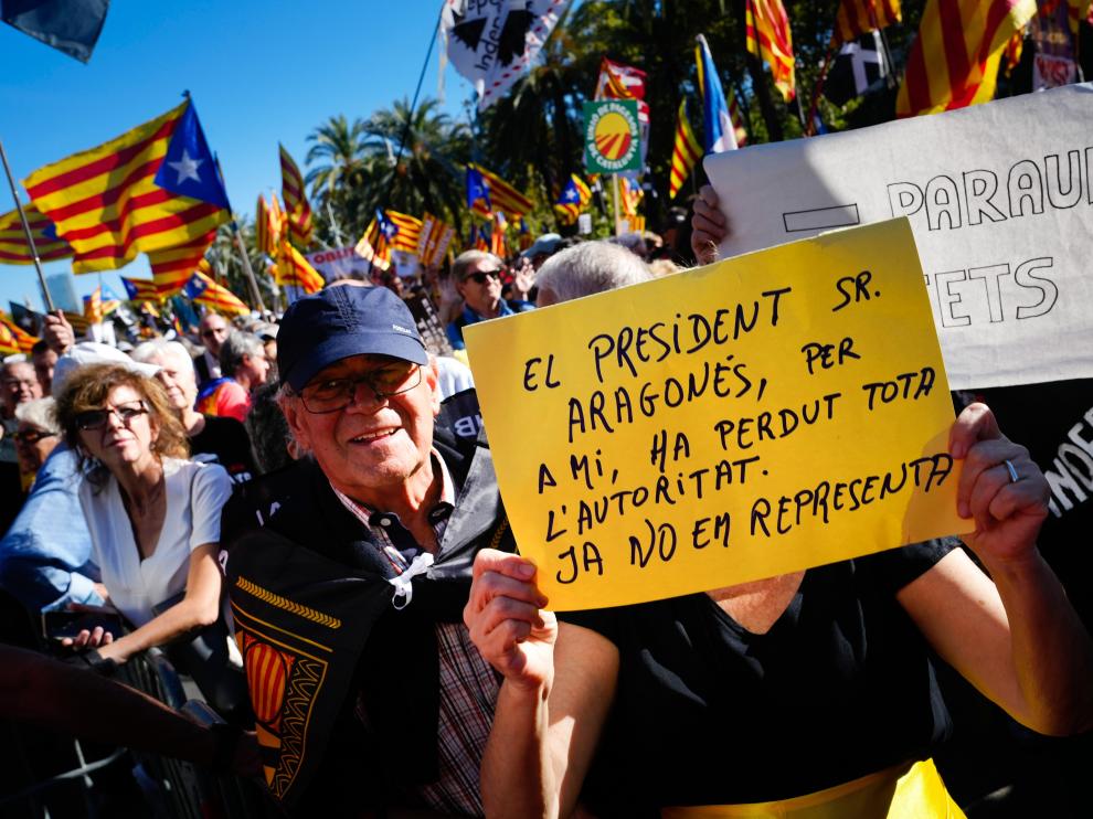 Manifestantes con pancartas contra el presidente catalán Pere Aragonès