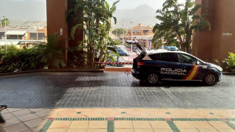 A Spanish National Police car is parked outside a hotel under lockdown after a coronavirus case was identified in Adeje