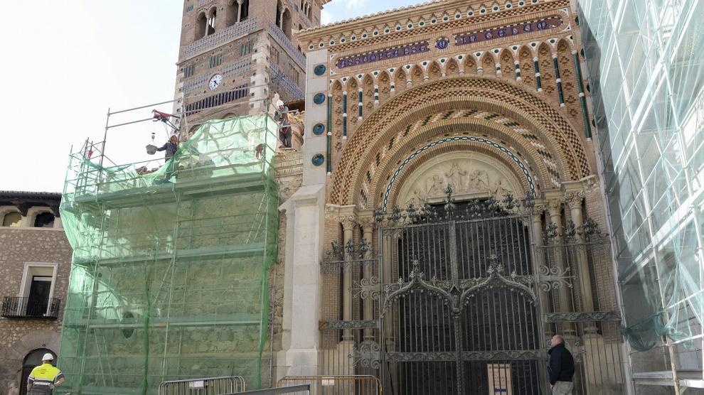 La verja del pórtico de la catedral, en medio de los andamios de las fachadas.
