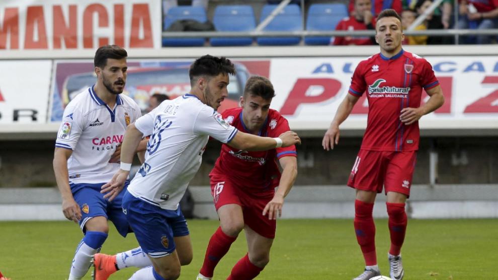 Isaac pugna con Concha ante la mirada de Javi Ros y Luis Valcarce en el partido del sábado ante el Numancia en Soria.