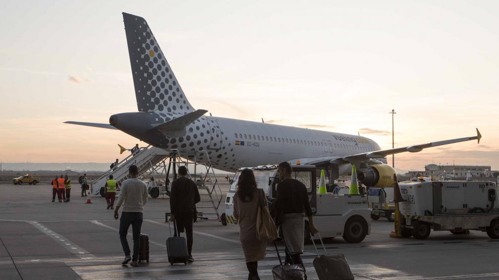 Varios viajeros se dirigen a un avión en el aeropuerto de Zaragoza.