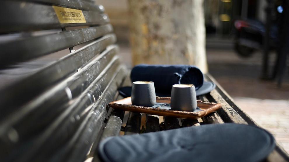 Ante la ausencia de terraza, la cafetería zaragozana ofrece a sus clientes almohadas y mantas para disfrutar de su consumición en la plaza del Justicia