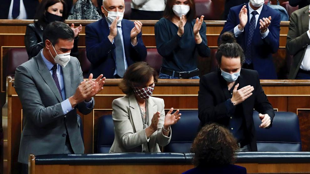 La ministra de Hacienda, María Jesús Montero, de espaldas, aplaudida por Pedro Sánchez, Carmen Calvo y Pablo Iglesias.