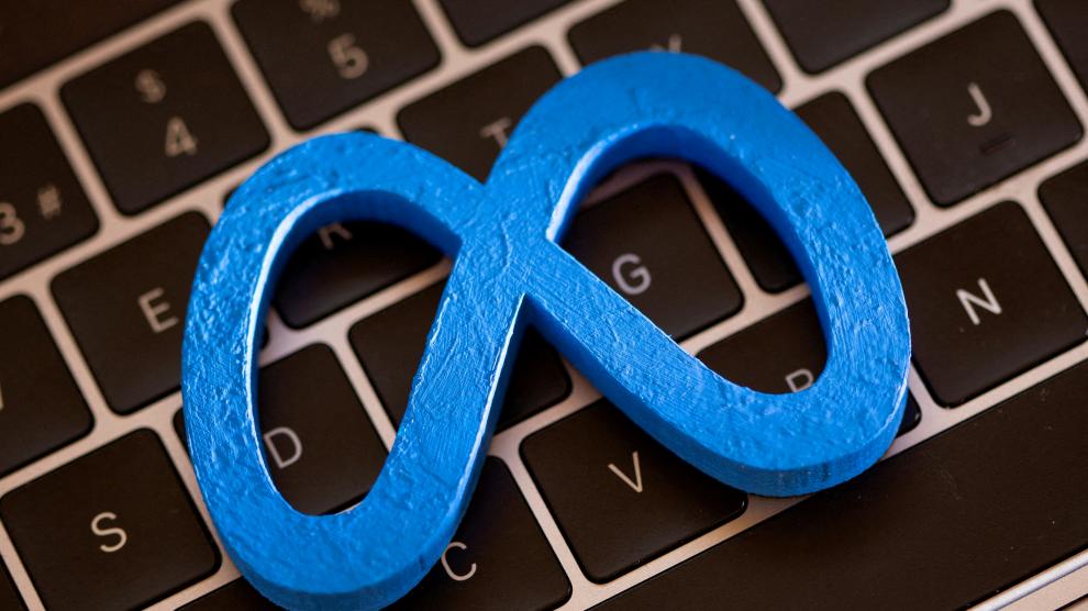 FILE PHOTO: A 3D printed Facebook's new rebrand logo Meta is placed on laptop keyboard in this illustration