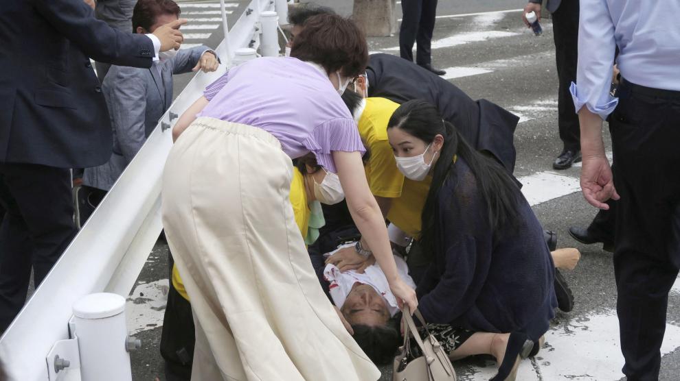 Former Japanese prime minister Shinzo Abe lies on the ground after apparent shooting during an election campaign in Nara, Japan
