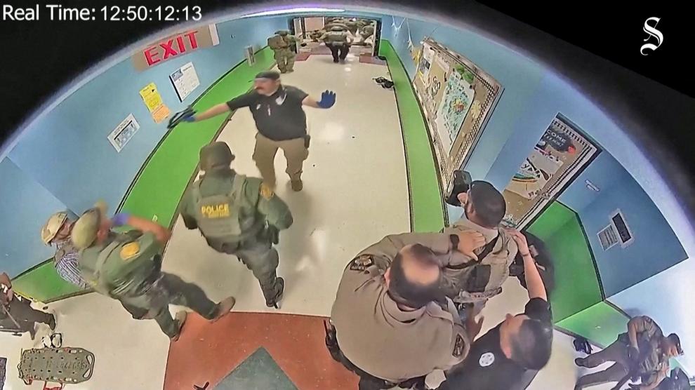 Police arrive to search hallways after Salvador Ramos entered Robb Elementary school to kill 19 children and two teachers in Uvalde, Texas, U.S. May 24, 2022 in a still image from school surveillance video obtained by the Austin American-Statesman newspaper.    Austin American-Statesman/Handout via REUTERS.  NO RESALES. NO ARCHIVES. MANDATORY CREDIT TEXAS-SHOOTING/