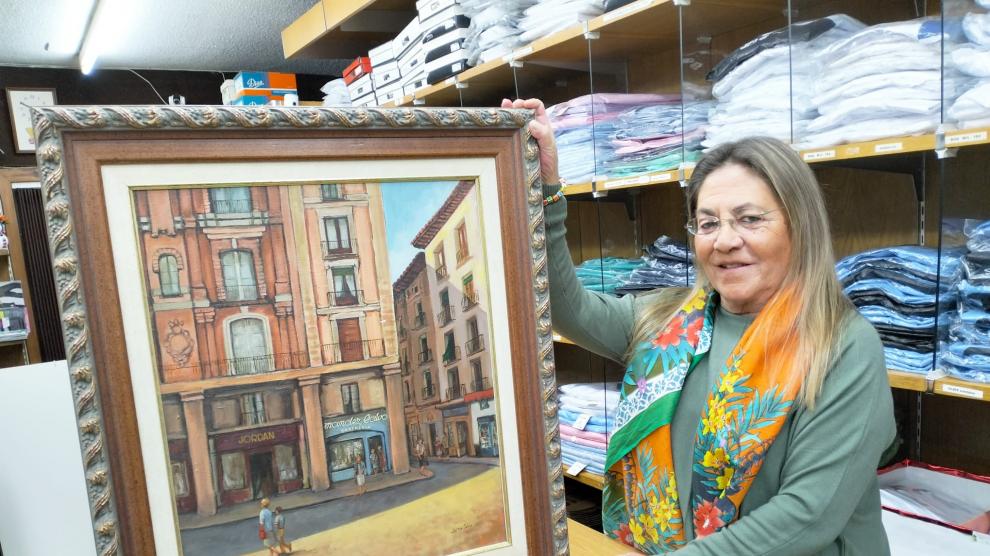 Mariví Fernández Ledesma, con un cuadro del primer local en Escuelas Pías