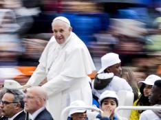 El papa lleva en su papamóvil durante la audiencia a ocho niños refugiados