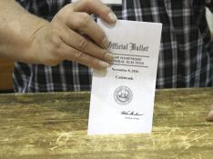 Un hombre deposita su voto para las elecciones presidenciales de Estados Unidos.