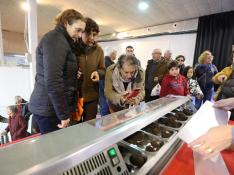 El público contempla los ejemplares que han participado en el concurso de mayor tamaño y calidad de trufas en Sarrión