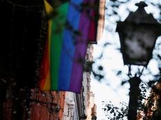 An LGBT flag hangs near surveillance cameras in Malasana neighbourhood, site of a suspected homophobic assault on a 20-year-old Spaniard in central Madrid