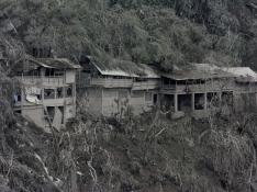 Damaged houses affected by the eruption of Mount Semeru volcano are seen in Pronojiwo village