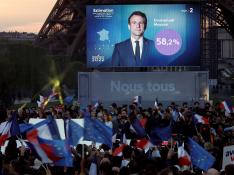 FILE PHOTO: Supporters of President Emmanuel Macron wave French and European Union flags in reaction to his election victory, in Paris, France